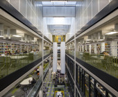 Interior view: View overlooking the Helpdesk and reception showing the large sound baffles, study areas and shelving/stock.